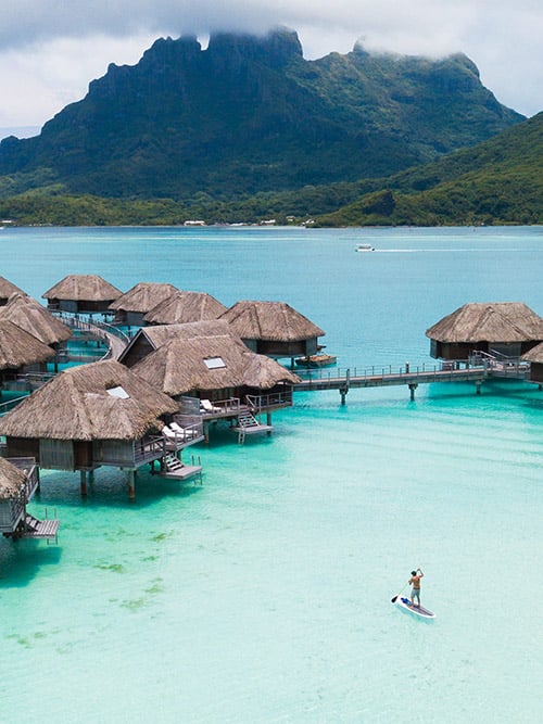 Maldives Vs Bora Bora For Couples: Which Is Better? Bora Bora lagoon with Mount Otemanu and overwater bungalows from above